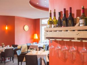 A selection of wines and wine glasses inside of the restaurant "La Vie" at the wellness hotel SCHWARZWALD PANORAMA