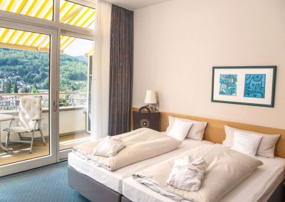 An extraordinary room with a balcony and a panoramic view of the black forest, located in the selfness hotel SCHWARZWALD PANORAMA